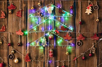 Christmas ornaments hanging on string on wood