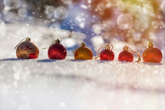 Row of Christmas ornaments in the snow