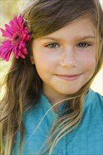 Smiling girl with flower in her hair
