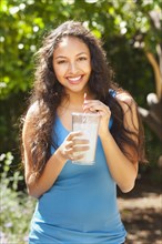 Mixed race woman drinking lemonade outdoors