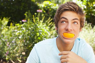 Caucasian teenager playing with orange
