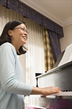 Chinese woman playing piano