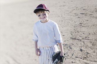 Caucasian boy smiling on baseball field