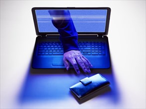 Hand of hacker reaching for wallet from screen of laptop