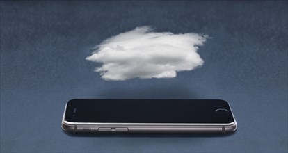 Cloud floating over cell phone