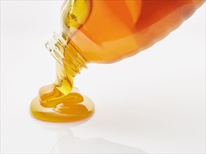 Honey pouring from bottle