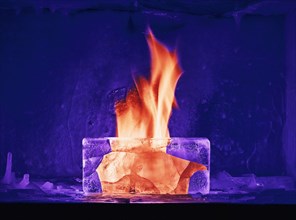 Orange flame burning in purple ice