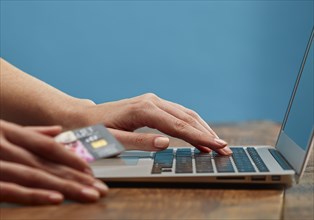 Hands of woman online shopping with laptop