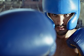Hispanic boxer training in gym