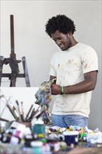 Black artist working in art studio