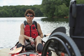 Caucasian paraplegic woman sitting in kayak