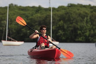 Caucasian woman rowing kayak