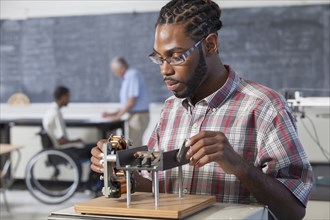 Student performing experiment in science classroom