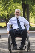 Caucasian businessman in wheelchair outdoors
