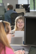 Caucasian businesswoman with Down Syndrome working in office