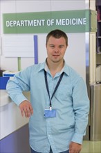 Caucasian man with Down Syndrome working in hospital