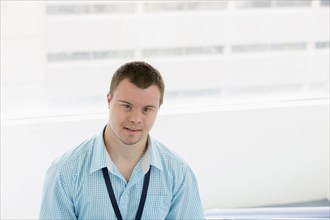Caucasian man with Down Syndrome smiling in hospital