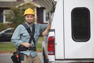 Caucasian worker smiling at truck