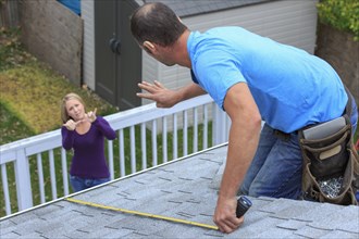 Caucasian homeowner signing to deaf roofer