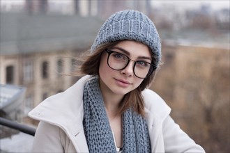 Caucasian woman wearing eyeglasses with scarf and hat