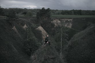 Caucasian woman sitting on hill