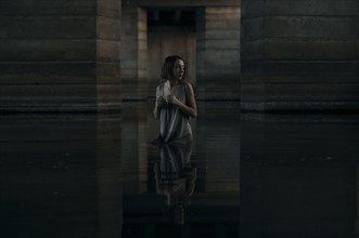 Caucasian woman standing waist deep in water