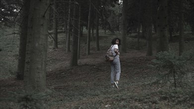 Fearful woman running in woods