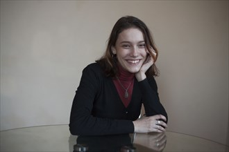 Portrait of smiling Caucasian woman sitting at table