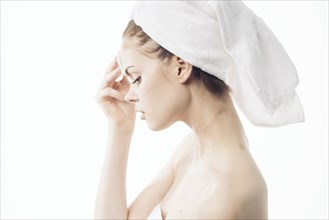 Caucasian woman cleaning forehead with pad