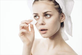 Caucasian woman cleaning eye with pad