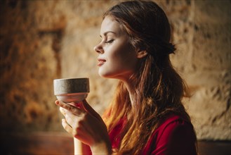 Caucasian woman enjoying aroma of cup of tea