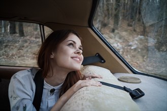 Caucasian woman in back seat of car looking up