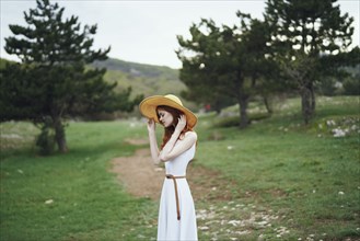 Woman wearing sun hat standing in field