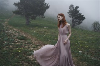Caucasian woman wearing a dress in field