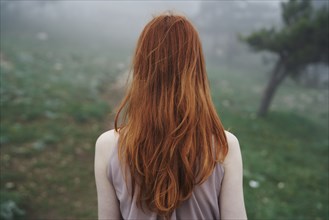 Rear view of Caucasian woman with red hair