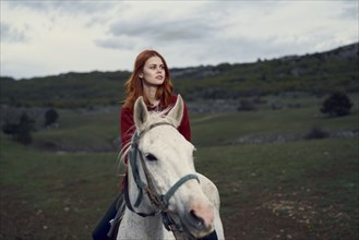 Caucasian woman riding horse