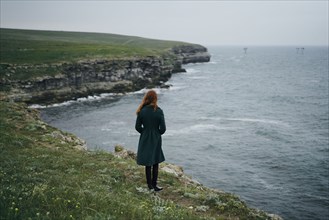 Caucasian woman standing near ocean