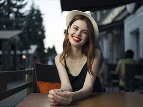 Caucasian woman at sidewalk cafe smiling