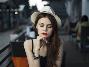 Pensive Caucasian woman at sidewalk cafe