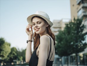 Portrait of smiling Caucasian woman holding hat