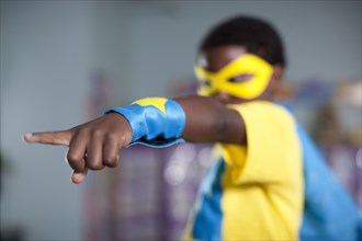 African American boy playing in superhero costume
