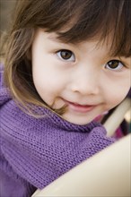Close up of young Asian girl smiling