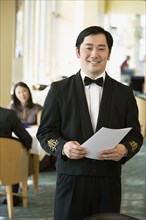 Asian male waiter at upscale restaurant