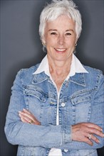 Senior woman in denim jacket smiling