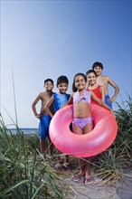 Hispanic children in bathing suits on beach