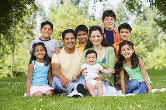 Portrait of Hispanic family in grass