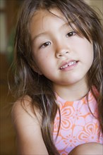 Close up of young Asian girl indoors