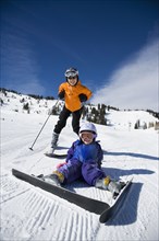 Asian mother and daughter skiing