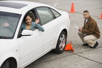 African teenager running over traffic cone at drivers test