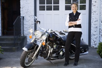 Senior African American woman next to motorcycle